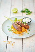 Vegan kidney bean and millet skewers with a lime cream and mashed sweet potatoes and coconut