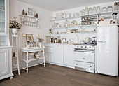 Vintage-style kitchen-dining room decorated entirely in white