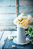 Spring flowers, narcissus, in vase on wooden table