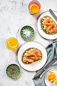 Slices of bread topped with avocado and smoked salmon for breakfast