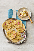 Moroccan baghrir with honey, pistachio nuts, rose petals and rose water