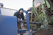 Farmer Repairing Farm Equipment