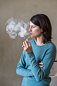 Woman using electronic cigarette