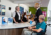 Patients at a hospital reception desk