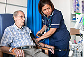 Elderly patient having his blood pressure measured