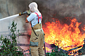 Firemen spraying water at trees, Florida, USA