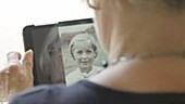Woman looking at old photos on device
