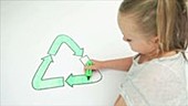 Girl colouring recycling symbol