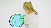 Girl colouring picture of earth