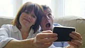 Couple photographing themselves on phone