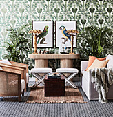 Safari-style seating area in front of green wallpaper with palm tree motifs