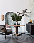 Urban jungle style seating area with wooden table and palm tree floor lamp next to alcove