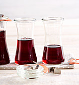 Homemade sour cherry syrup in preserving jars
