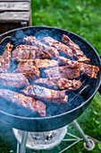 Marinated spare ribs being grilled