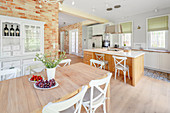 Dining table in open-plan, country-house-style kitchen