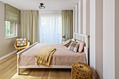 Striped wall in bedroom in pastel shades