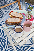 Sandwiches and coffee cups on folding table outside