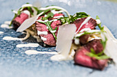 Rare roasted beef fillet with rocket and sauce Hollandaise