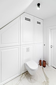 Toilet and fitted cupboards in elegant bathroom