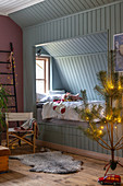 Pale blue cubby bed in festively decorated child's bedroom