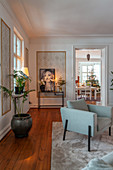 Pale blue armchair in living room with view of Christmas tree