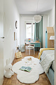 Small child's bedroom in pale blue and white