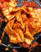 Pappardelle with tomatoes in a pan