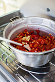 Tomato sugo being made on a camping stove