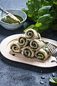 Vegan pancake rolls with red onions and pumpkin seed and basil pesto