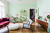 Sofas and armchairs, rosewood sideboard and brass shelves in living room