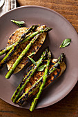Grilled asparagus with mint leaves on toasted bread