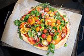 Pizza with tomatoe salad with truffle salami