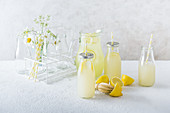Homemade lemonade in a jug and serving bottles