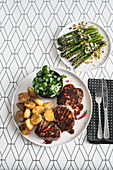 Beef fillet with balsamic and chocolate reduction, Seared asparagus with ricotta cheese and toasted nut topping