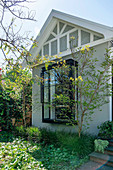 Residential house with white facade and bay window with black steel frame