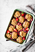 Vegan cobbler with rhubarb and berries in a baking dish