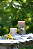 Pillar candles decorated with copper wire and wild summer flowers