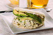 Famous Venezuelan arepa called queen pepeada, with avocado and chicken