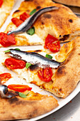 Tomatoes and anchovies pizza (detail)