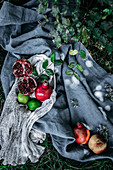 Bunch of assorted fresh fruits placed on pieces of cloth on green grass in nature