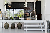 Offene Küche und Essbereich auf Split Level mit Glasabtrennung und weißer Treppe