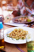 Dinner table with a plate of Spaghetti with bottarga