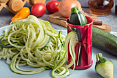Making zucchini noodles with spiral vegetable slicer