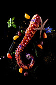 Roasted octopus with tomatoes and edible flowers