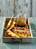 Caramelised Java pepper pineapple on stick with a rum and coconut sauce