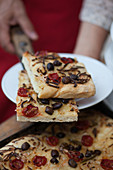 Freshly baked focaccia with tomatoes and olives
