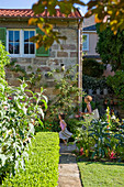 Woman and girl walking through Mediterranean garden