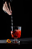 Negroni cocktail stirred with a bar stool
