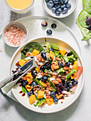 Spring mix salad with mango, blueberries and prosciutto