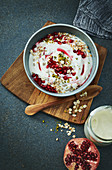 A bowl of pomegranate granola with yoghurt